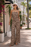 ASTR the Label Eva Pant Style ACP7429 in Brown Tropical. Woman wearing a brown botanical border print scarf tank and wide leg pant matching set while shopping in Palm Beach with a white sun hat and woven shoulder bag.