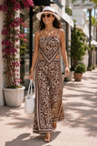 ASTR the Label Eva Pant Style ACP7429 in Brown Tropical. Woman walking in a brown and ivory resort matching set showing the movement of the flowing wide leg pants and border print.