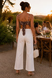 ASTR the Label Clothing Eva Top Style ACT19474 in Brown Tropical. Brown botanical print pointed hem tank paired with white denim, gold jewelry, and clear kitten heel sandals.