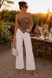 ASTR the Label Clothing Eva Top Style ACT19474 in Brown Tropical. Woman wearing the Eva Pointed Hem Spaghetti Strap Tank Top styled with white wide leg jeans for a golden hour dinner in the Hudson Valley.