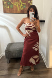 ASTR the Label Clothing Annabeth Dress Style ACDR101745NC in Brown Floral. A woman takes a mirror selfie wearing a strapless maxi dress with a brown base and a large cream floral pattern. She is standing in a fitting room wat bfree boutique in warwick, ny