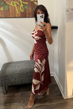 ASTR the Label Clothing Annabeth Dress Style ACDR101745NC in Brown Floral. A woman takes a mirror selfie wearing a strapless maxi dress with a brown base and a large cream floral pattern. She is standing in a fitting room wat bfree boutique in warwick, ny