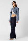 “Beige Botany asymmetrical cropped denim jacket in medium denim wash. Style Number A2450J A stylish, contemporary jacket with an asymmetrical design, crafted in a versatile medium denim wash. The cropped length pairs well with high rise bottoms and a fitted top, creating a fashionable and confident ensemble.”
