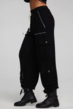 A pair of Chaser Billy Shadow Black Jogger Pants featuring contrast stitching, side cargo pockets, an elastic waist, and deep front pockets. The joggers are shown paired with the matching Cooper Shadow Black Top, creating a stylish and comfortable ensemble. Style Number CW9769-SHDW