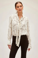 Fifteen Twenty tie neck top in ivory chain link print Italian crepe fabric, featuring soft tie at V-neck and billowy blouson sleeves for an elegant and modern look. Style Number 3F30548 Prt