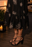 Greylin Clothing Paige Layered Ruffle Midi Dress Style G264D7178 in Midnight. Close-up of the Paige Dress layered ruffle hem highlighting movement and texture.