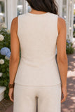 Back close-up of the Raven knit vest showing its rounded neckline, contour seams and untucked hemline.