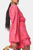 A pink Hemant & Nandita Indu Mini Dress with a shimmery fabrication. The dress features a ruffle tiered hem, self-tie drawn waist, and a one-shoulder silhouette, creating a modern and elegant look.