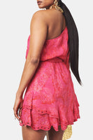 A pink Hemant & Nandita Indu Mini Dress with a shimmery fabrication. The dress features a ruffle tiered hem, self-tie drawn waist, and a one-shoulder silhouette, creating a modern and elegant look.