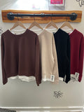 The Bfree Intentional Crew in brown, Stone, Black and Merlot on hangers in the fitting room at Bfree in Warwick NY. A Faux Layered Fleece sweatshirt styled and modeled at Bfree Warwick, NY