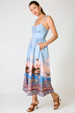 Line and Dot Clothing Pernille Maxi Dress Style LD6071B in Blue Multi. Tie adjustable spaghetti strap partial smocked back summer tropical landscape print maxi dress