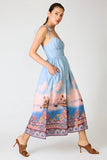 Line and Dot Clothing Pernille Maxi Dress Style LD6071B in Blue Multi. Tie adjustable spaghetti strap partial smocked back summer tropical landscape print maxi dress