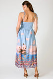 Line and Dot Clothing Pernille Maxi Dress Style LD6071B in Blue Multi. Tie adjustable spaghetti strap partial smocked back summer tropical landscape print maxi dress