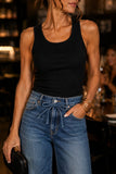Rails Clothing Dover Palazzo Denim Pant Style 730A-255D-8419 in Boondocks. Woman wearing the Dover Wide Leg Palazzo Jeans with a black ribbed tank top, black strappy heels and a woven blck clutch at an upscale restaurant. Mid-rise drapey denim palazzo jeans with an adjustable tie waist styled for an edgy date night or dinner with friends.