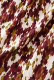 Macro detail of the textured chiffon fabric featuring an abstract burgundy, ivory, and olive floral print.