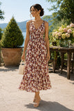 Woman wearing a floral smocked midi dress with a V-neckline, clear strap kitten heel slide sandals, gold jewelry, and a beaded handbag at a daytime outdoor Hudson Valley patio party. Rails Clothing Marciana Dress Style 913A-191G-8768 in Cardinal Floral