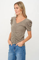 Woman wearing a green top and blue jeans on a white background; Six Fifty Clothing Camilla Tee Style SF3659 in Army Green;Puff Short Sleeve Tee;Ruched Puff short sleeve summer tee; 