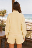 Varley Davidson Sweat Style VAR01080 ANIF in Anise Flower Paired with the Atrium igh Rise Short 4.5. Close-up of the Davidson Sweat showing its stand collar, relaxed back, dropped shoulders and cropped hem