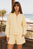 Varley Davidson Sweat Style VAR01080 ANIF in Anise Flower Paired with the Atrium igh Rise Short 4.5. Front close-up of the Varley Davidson Sweat showing its stand collar, half-zip neckline and dropped shoulders
