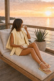 Varley Marla Button Placket Tank Style VAR03162 ANIF in Anise Flower. Woman wearing the Marla Tank and matching Anise Flower layers while sipping tea at sunset