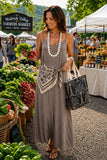 Vava By Joy Han Pom-Pom Maxi Sleeveless Dress Style VAVD119895 in Taupe. Taupe summer maxi dress with pom-pom detail adjustable spaghetti straps. Perfect for warm weather gatherings