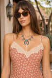 Z Supply Clothing Emela Iris Floral Midi Dress Style ZD263313 CHP in Chili Pepper. Close-up of the Emela Iris Floral Midi Dress creamy lace V-neckline, adjustable spaghetti straps and coral floral print